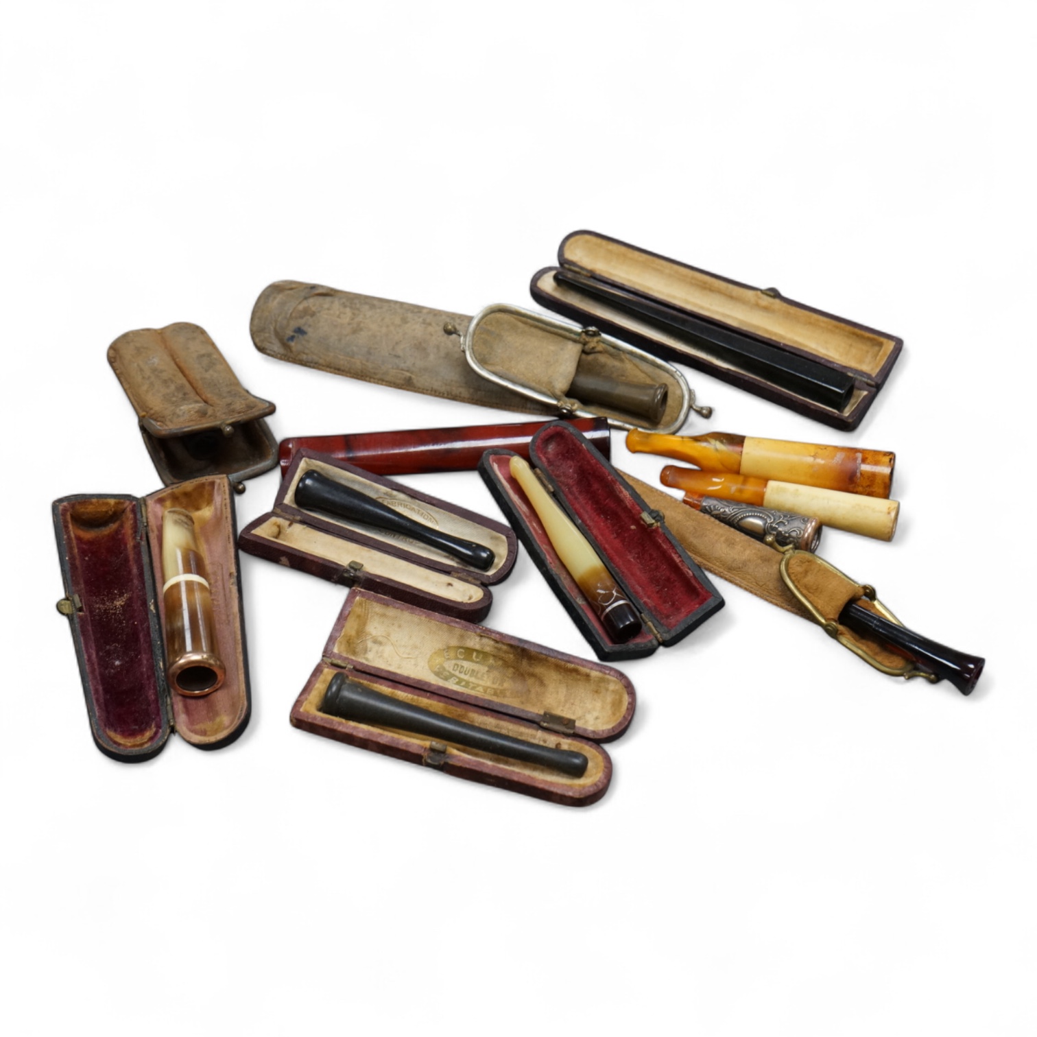 Twelve mixed cigarette and cheroot holders, some Cherry Amber, some with original cases